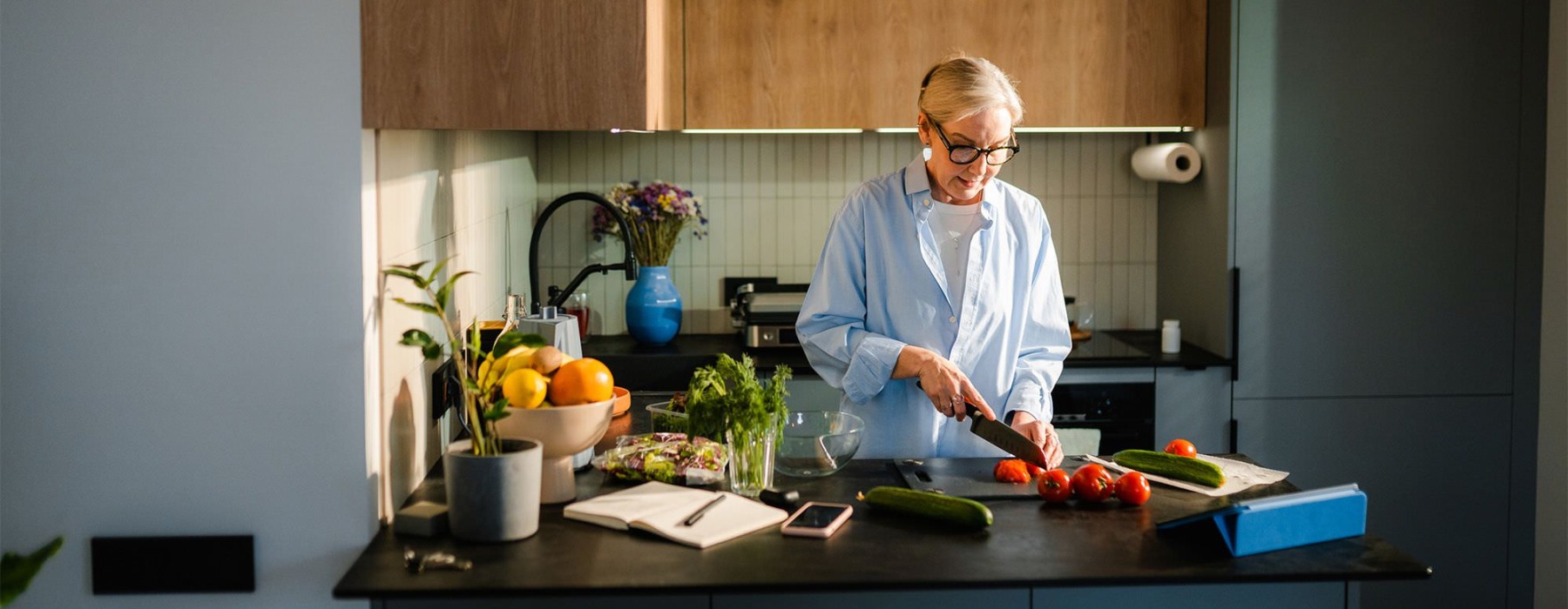 a woman cutting vegetables in the kitchen