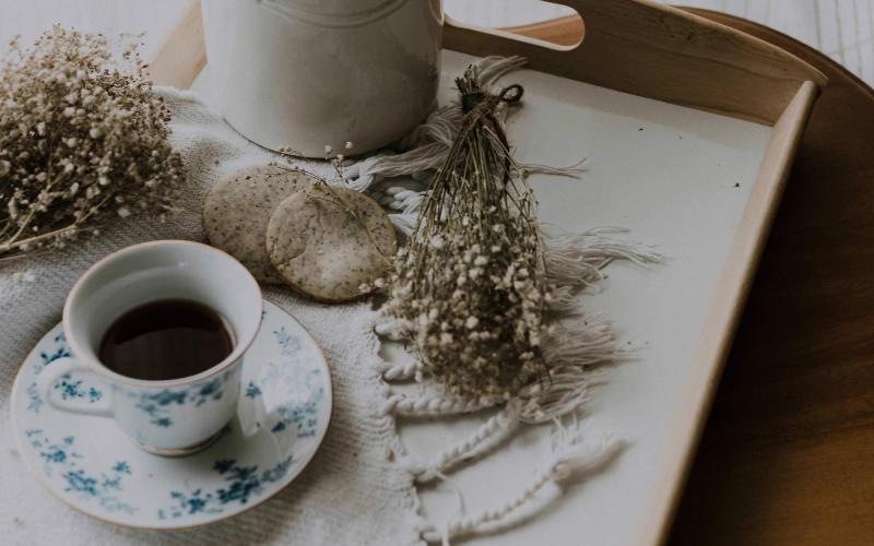 tea and cookies on a serving tray with baby's breath