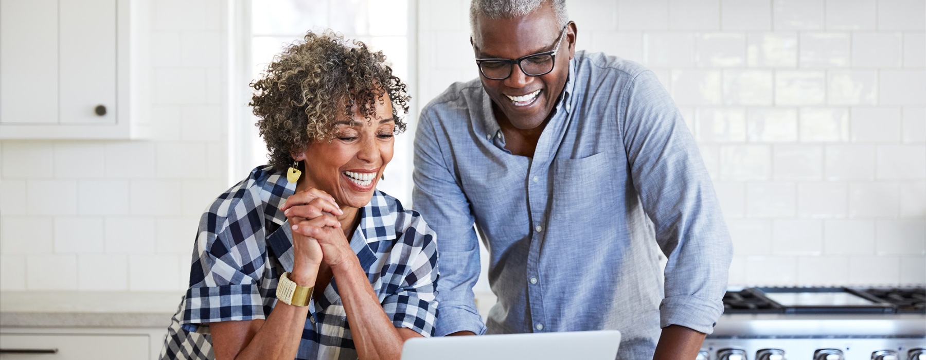 a couple smiling at a computer