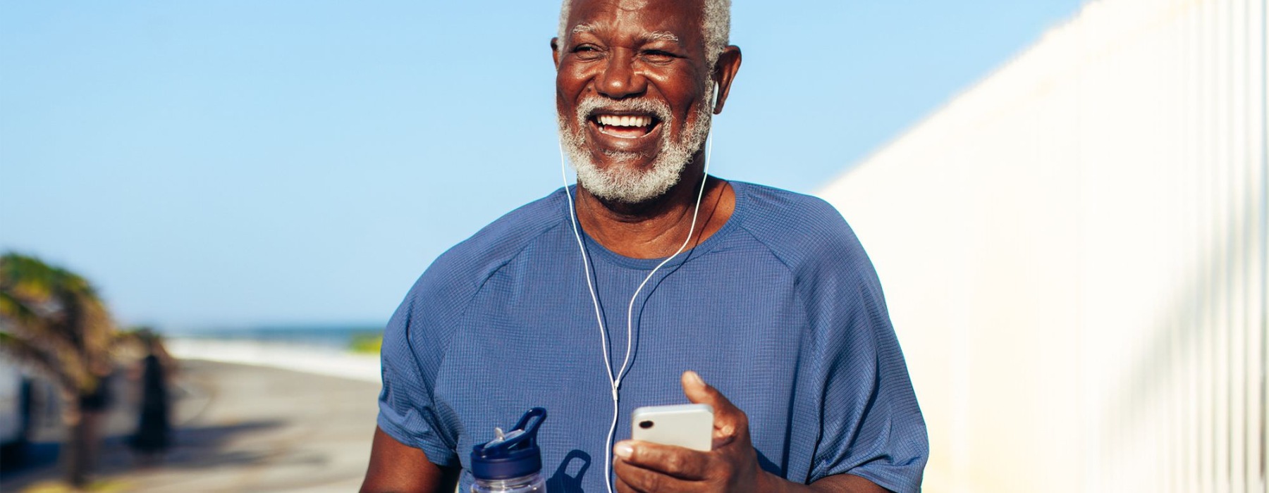 a man holding a water bottle while outdoors